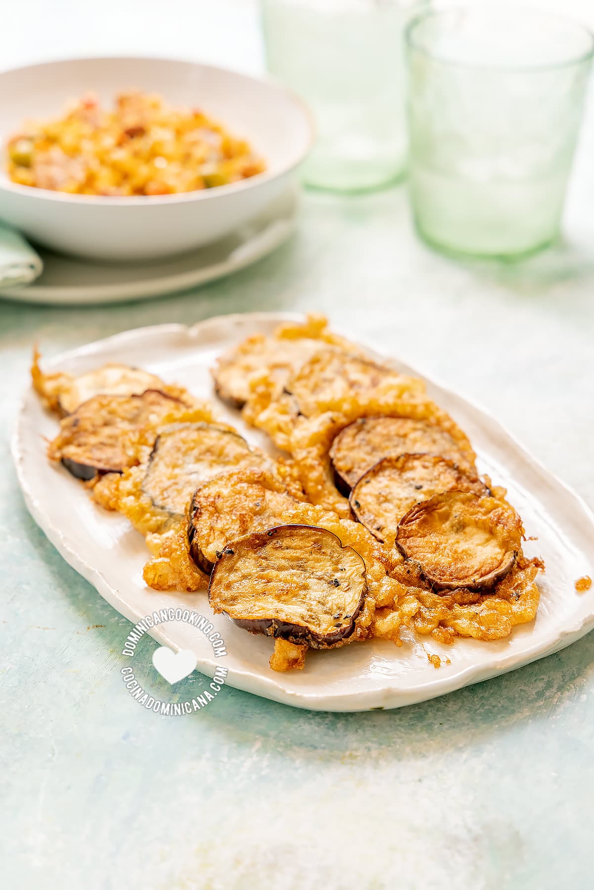 Torrejas de berenjenas (fried eggplants) served with rice.