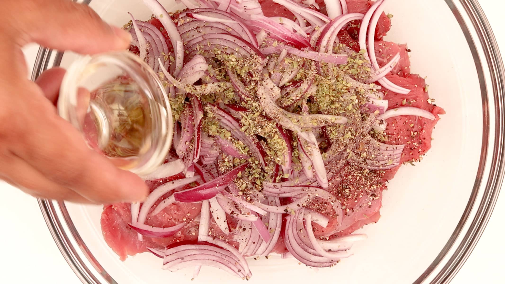 Seasoning the steaks.