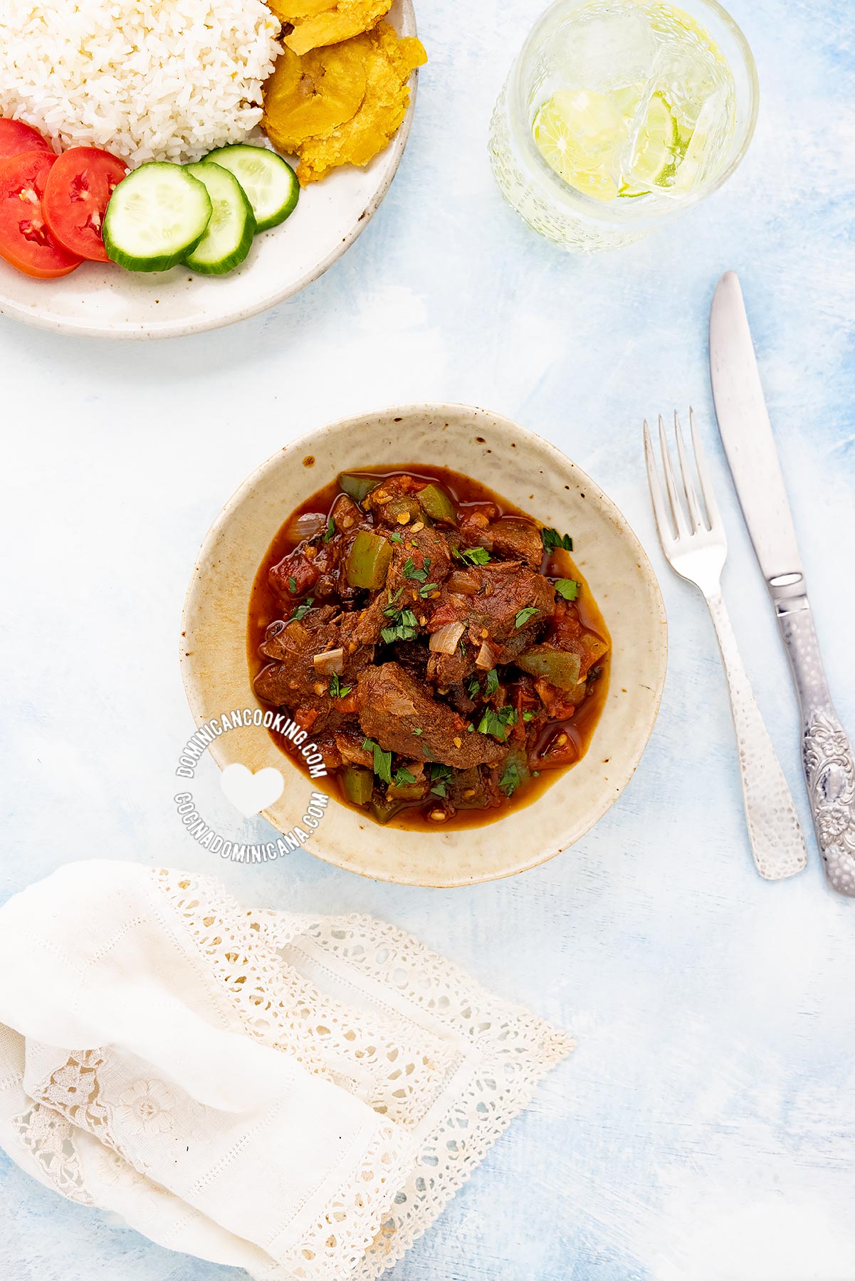 Carne de res guisada (dominican braised neef) served next to rice, tostones, and salad.