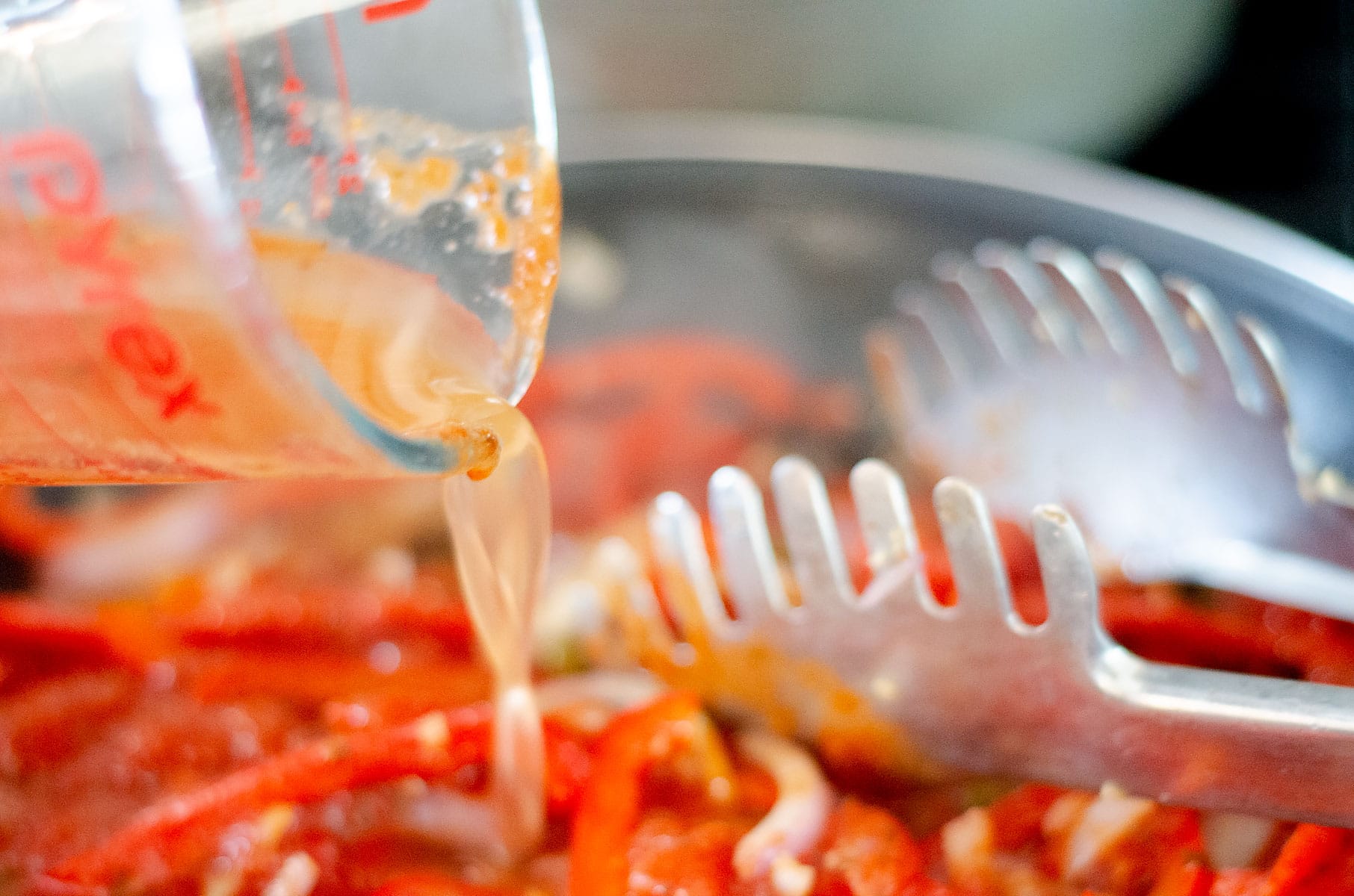 Adding water to the sauce.