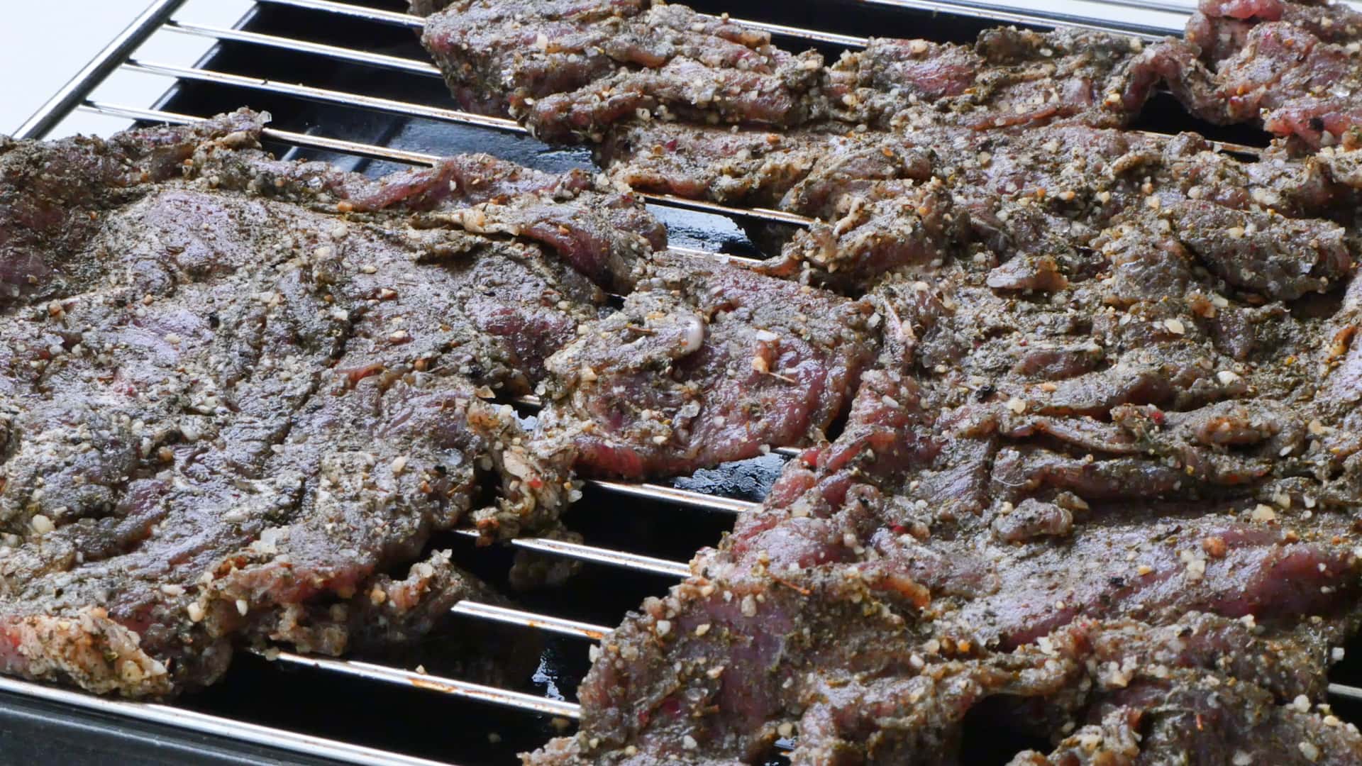 Meat in dehydrator tray.