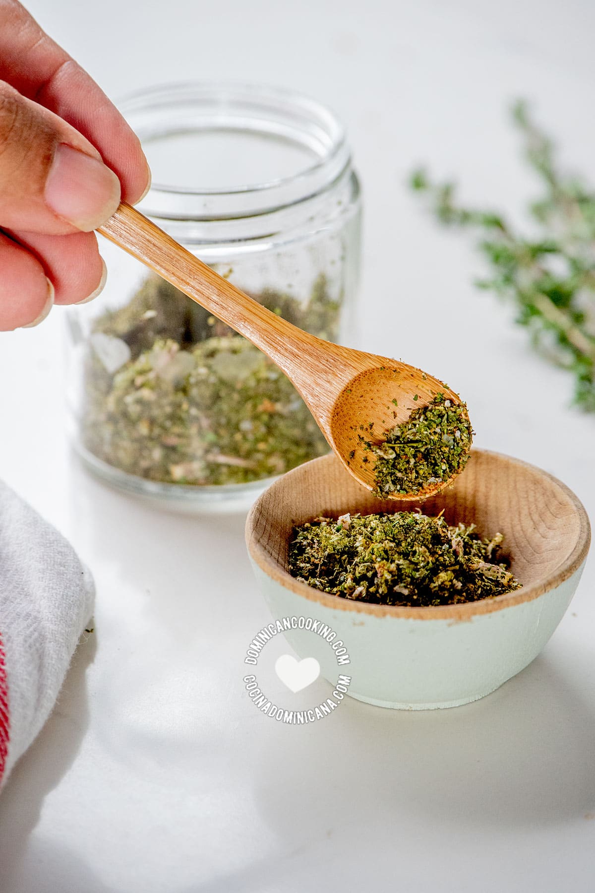 Hand scooping homemade seasoning powder.