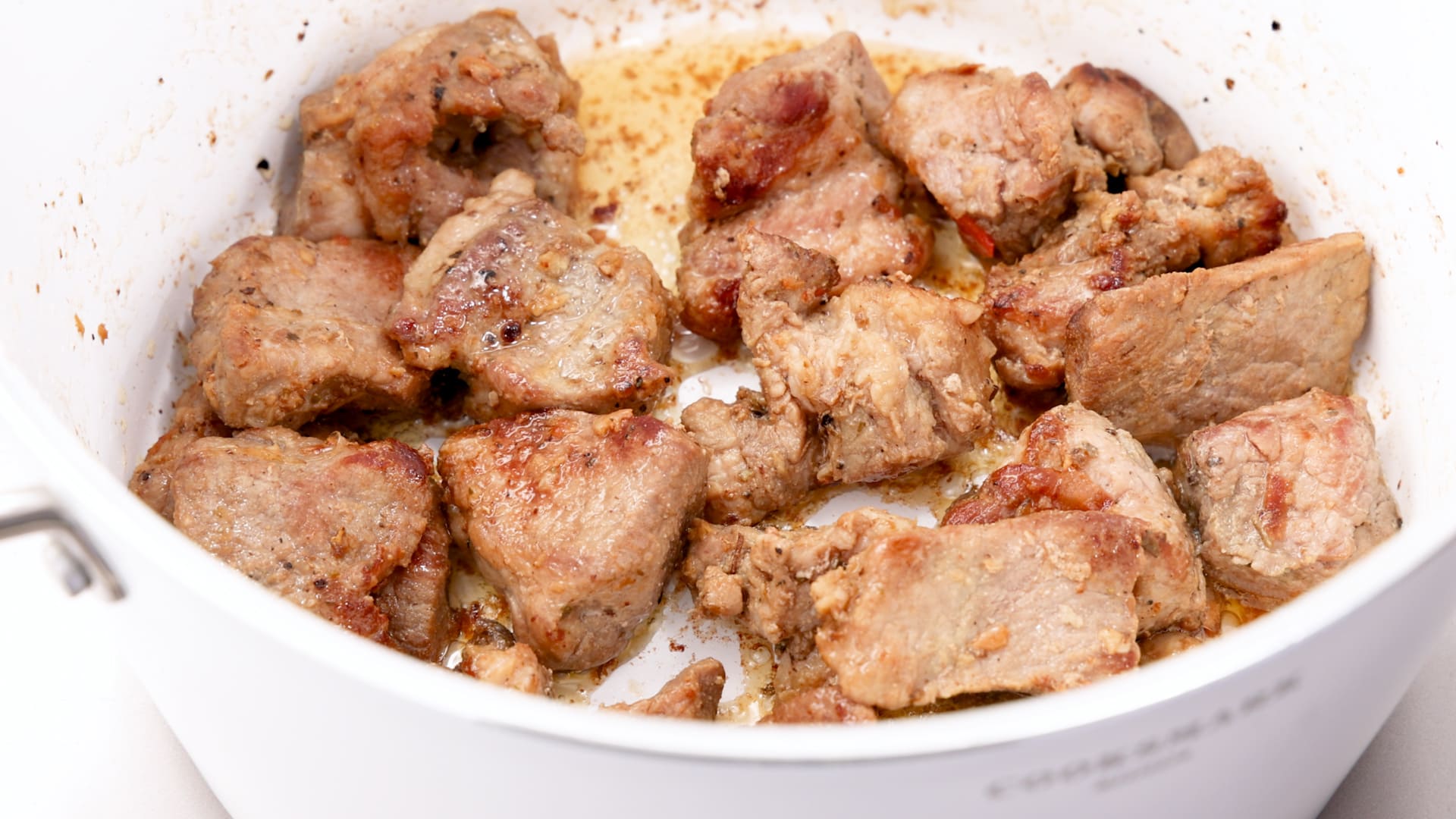 Browned puerco guisado meat.