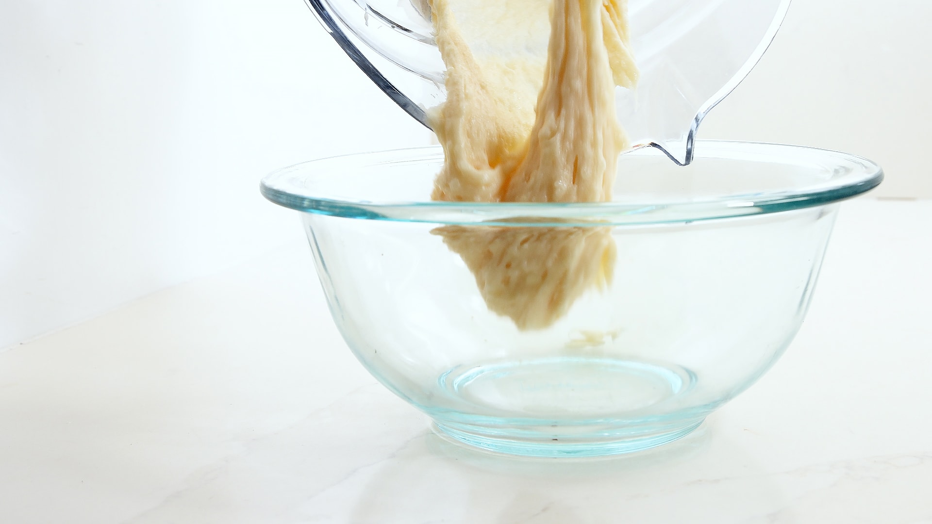 Pouring batter into bowl.