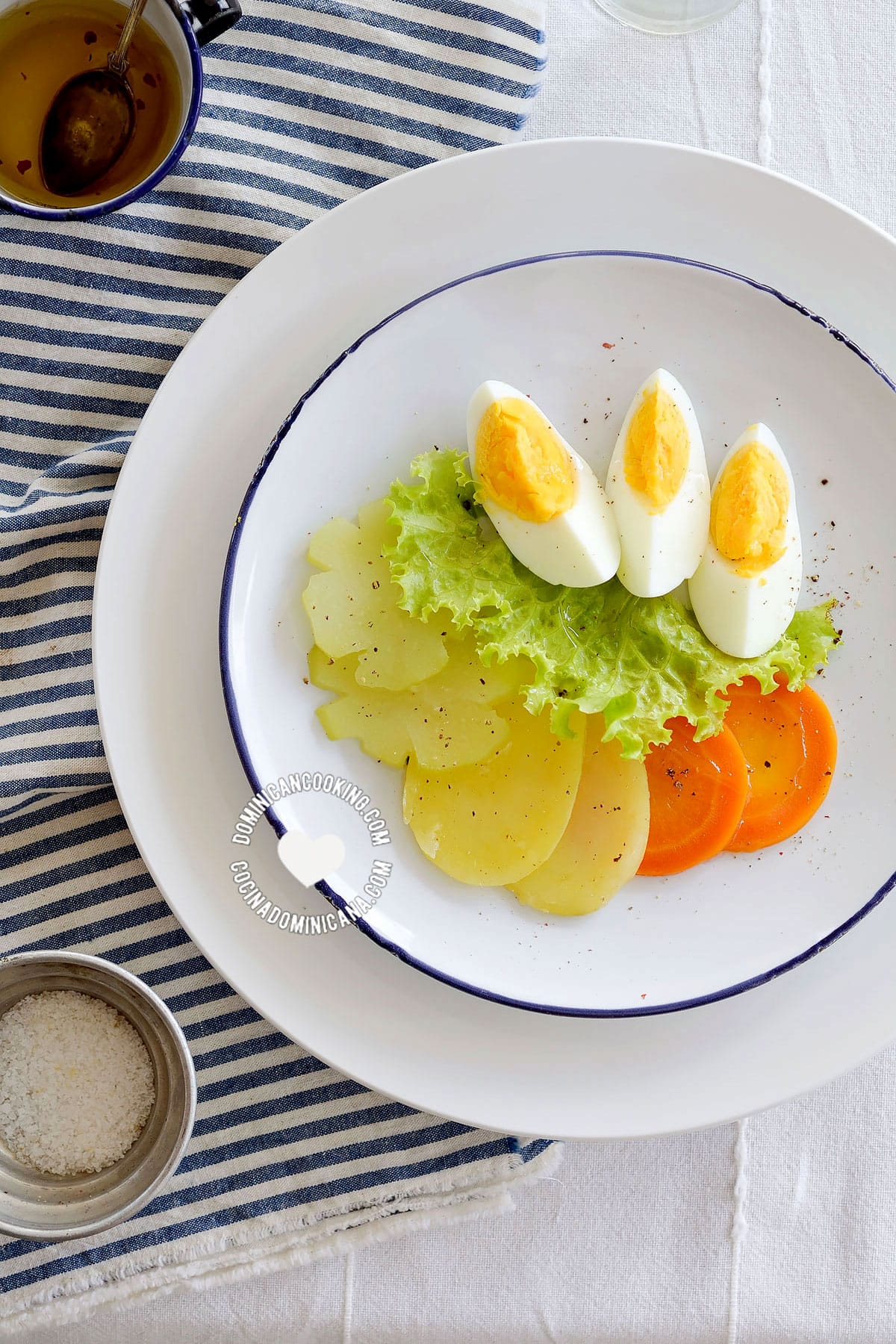 Ensalada hervida (boiled salad) served alongside vinaigrette seen from above.