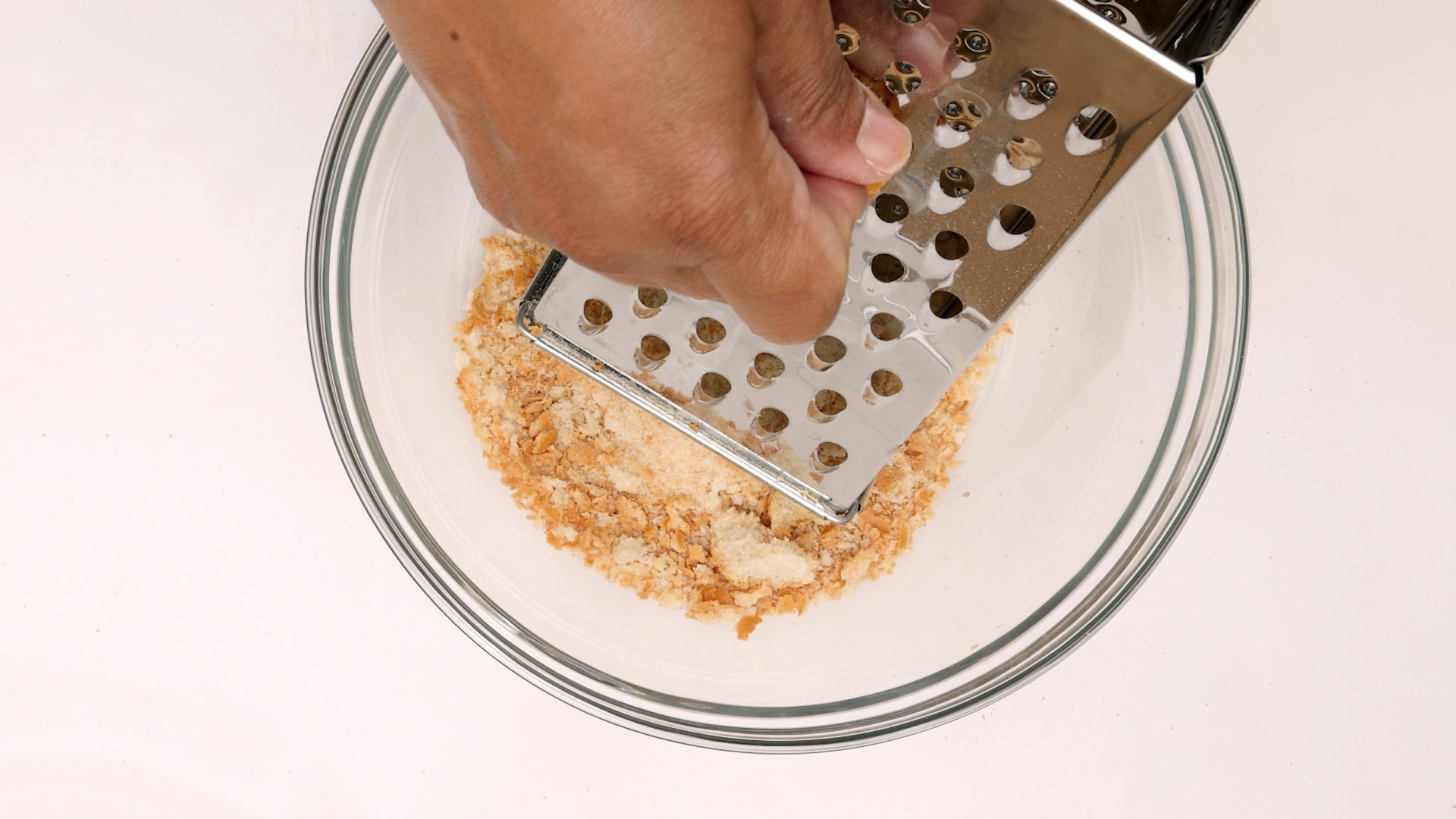 Grating bread.