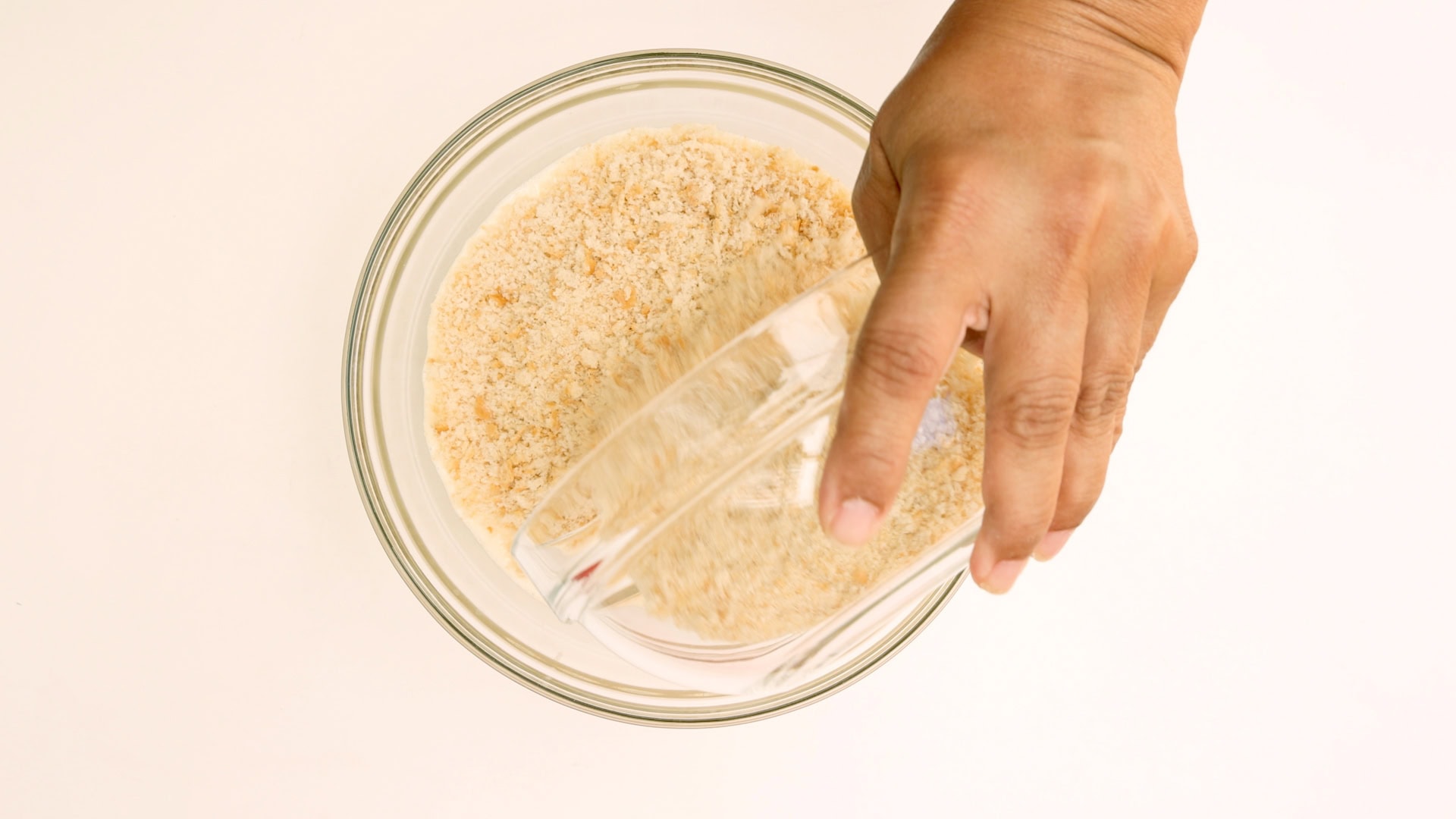 Adding bread to flan mix.