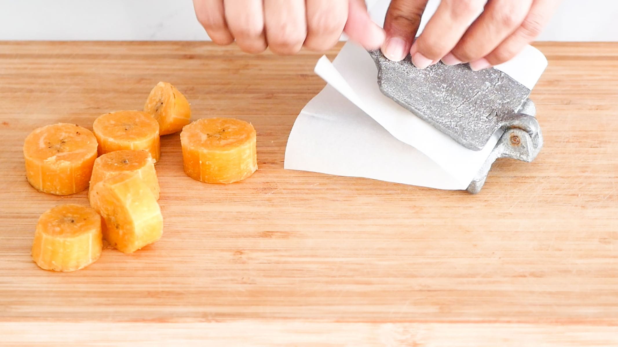 Flattening the plantains.