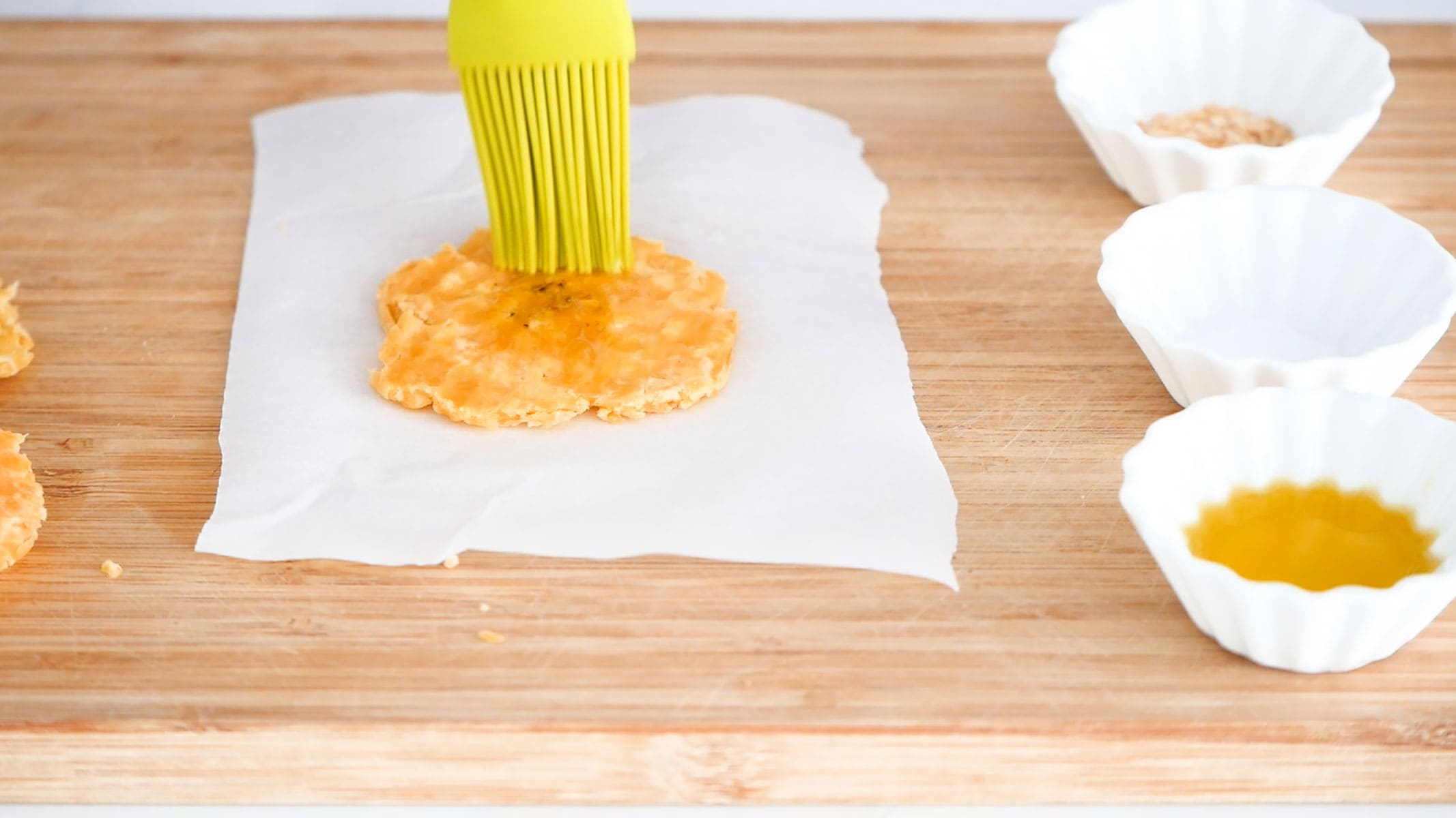 Brushing plantains with oil.