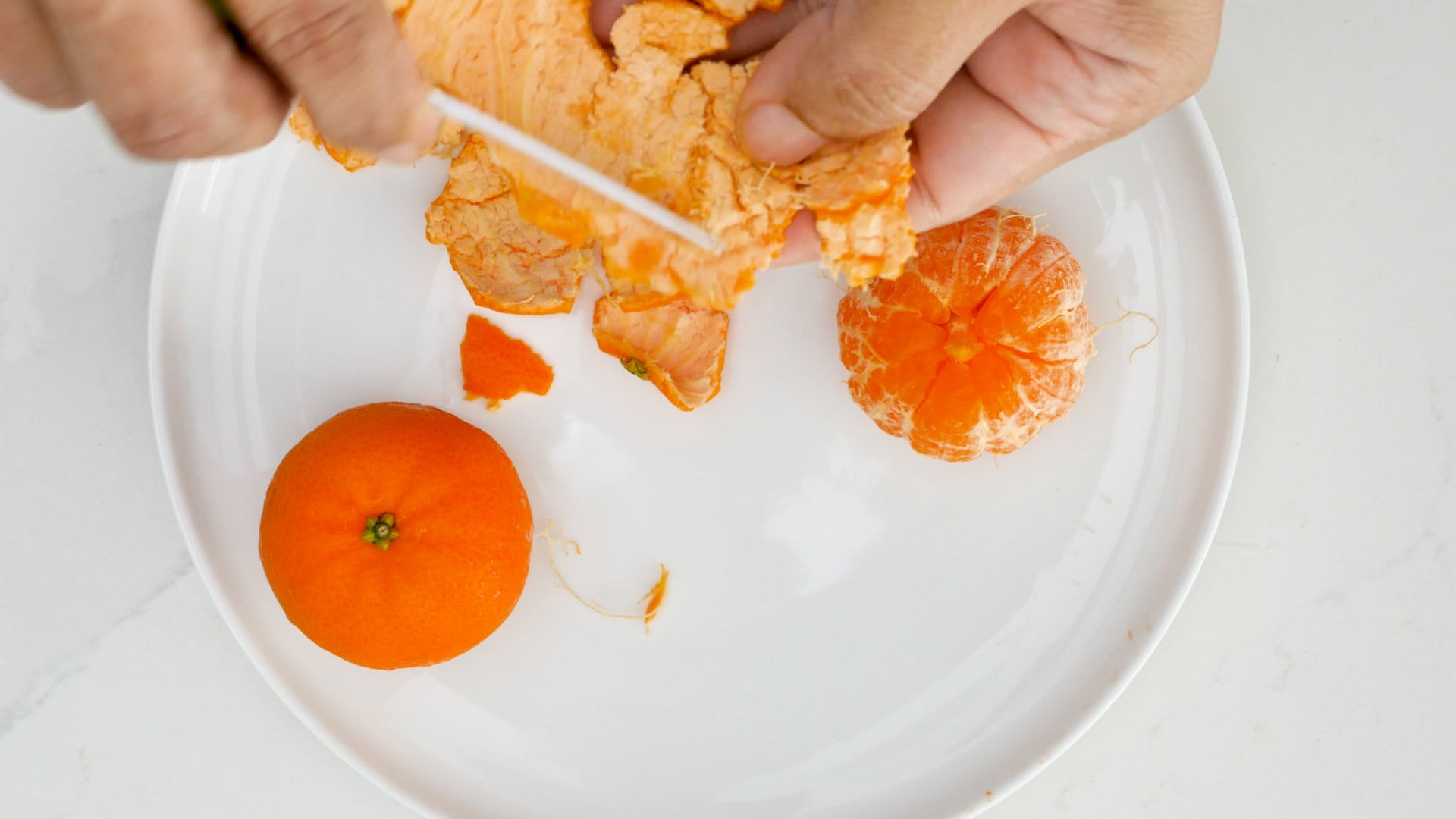 Scraping white from the rinds.