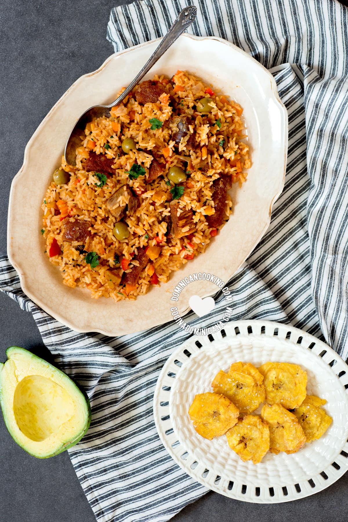 Locrio de chicharrón de cerdo (rice and pork crackling), with tostones and avocado.
