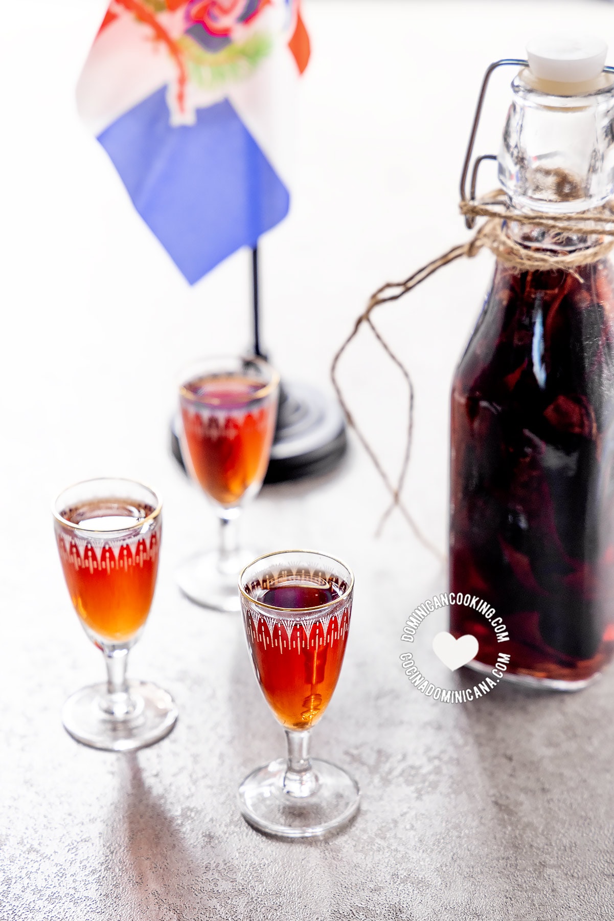 Glass shots and bottle of mamajuana spiced Dominican drink.