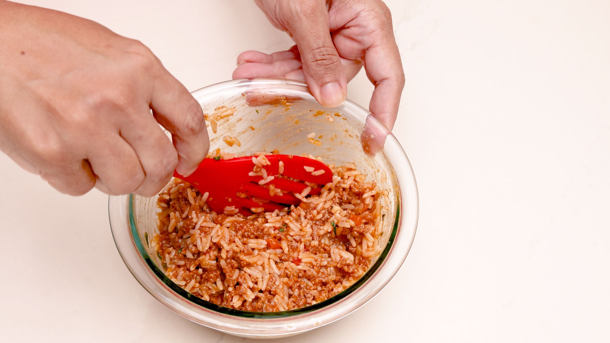 Mixing beef with rice.