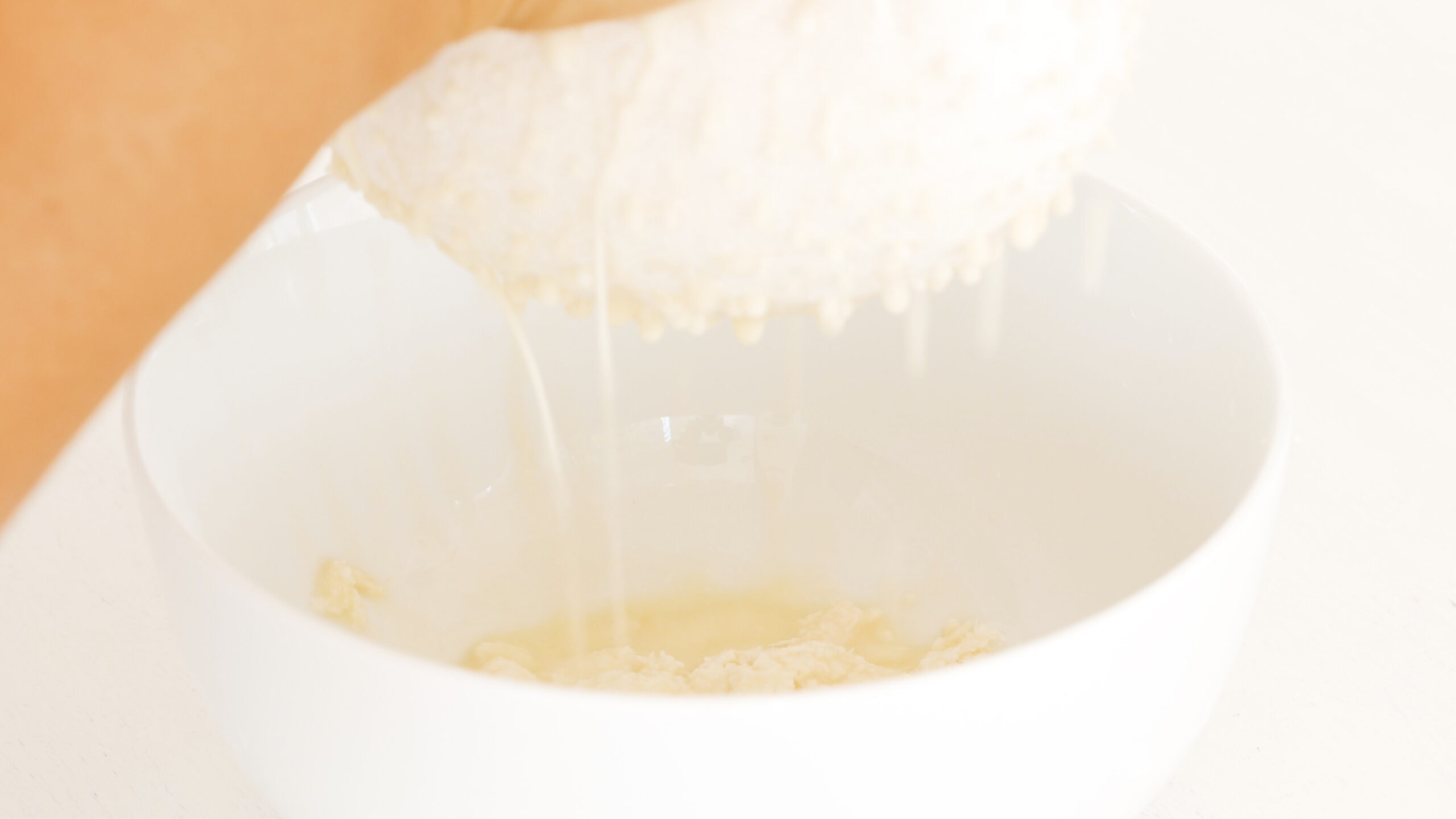 Squeezing out liquid from yuca.