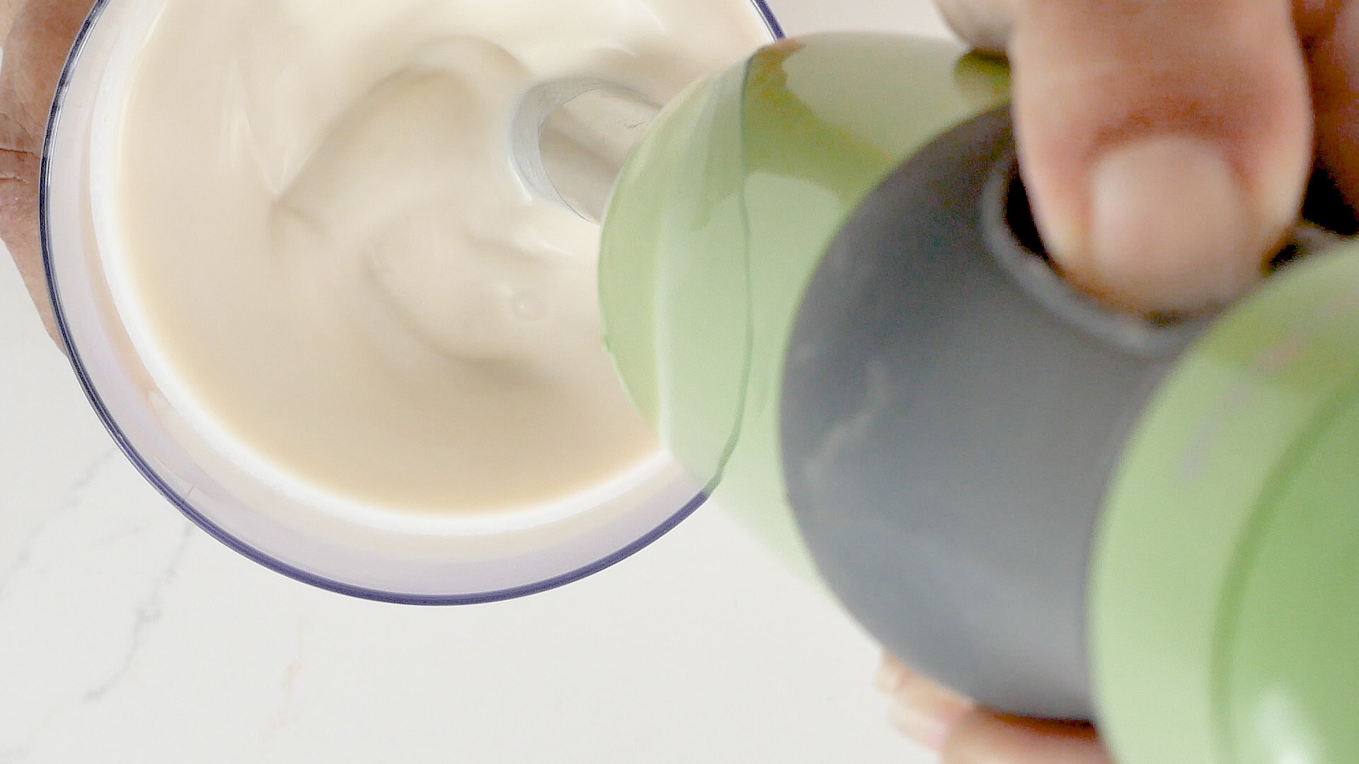 Mixing ingredients for coconut popsicles.