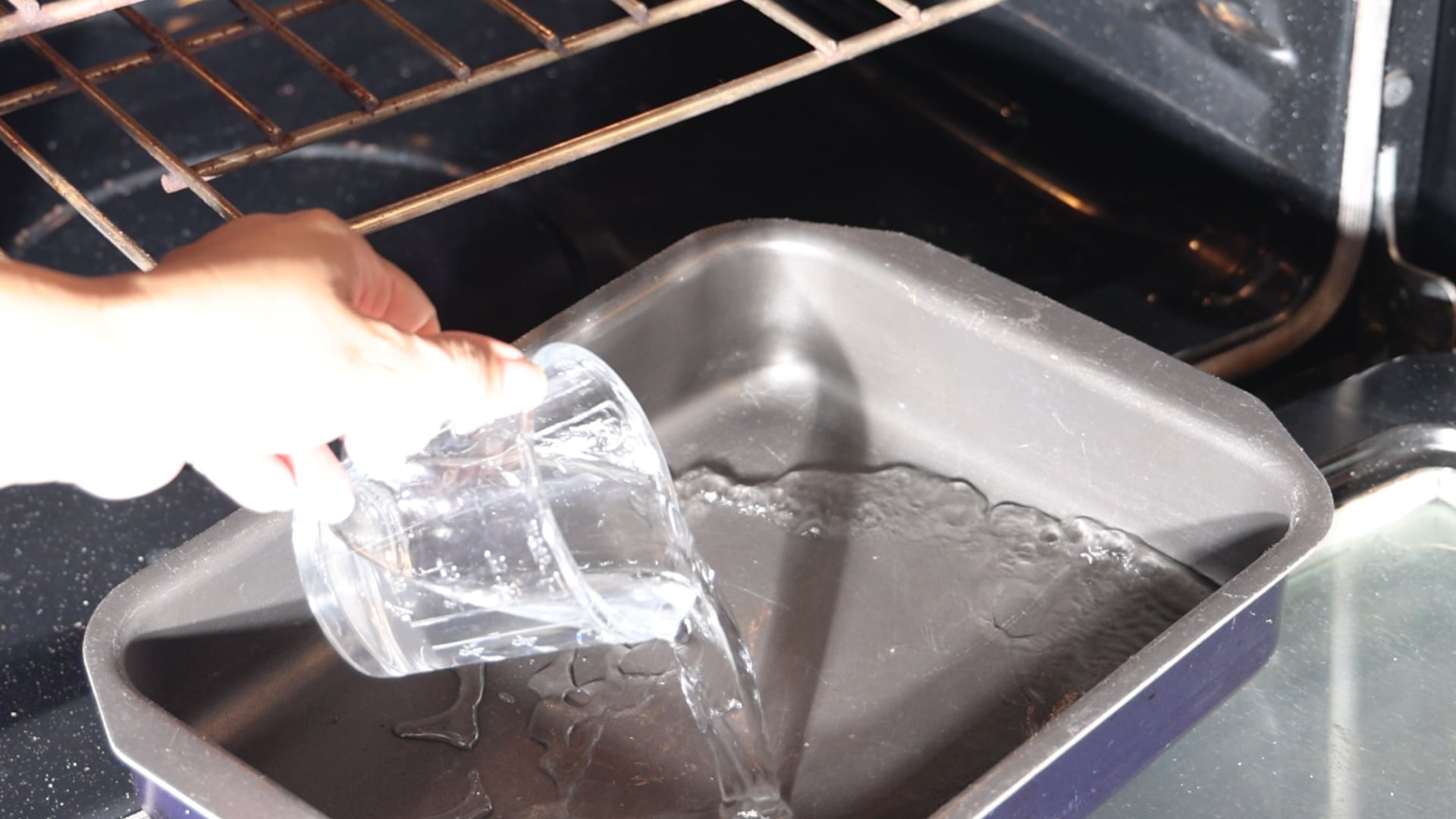 Adding water to pan.