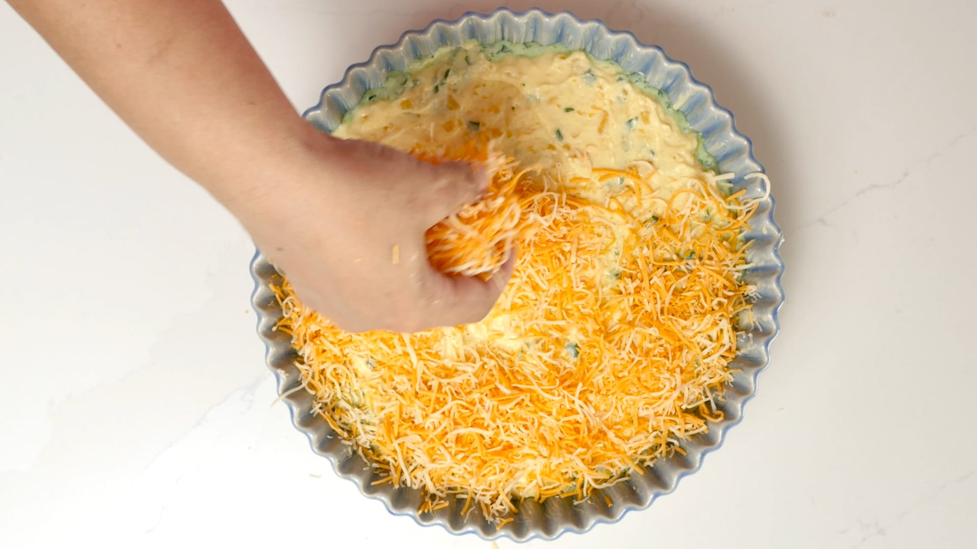 Covering with cheese.