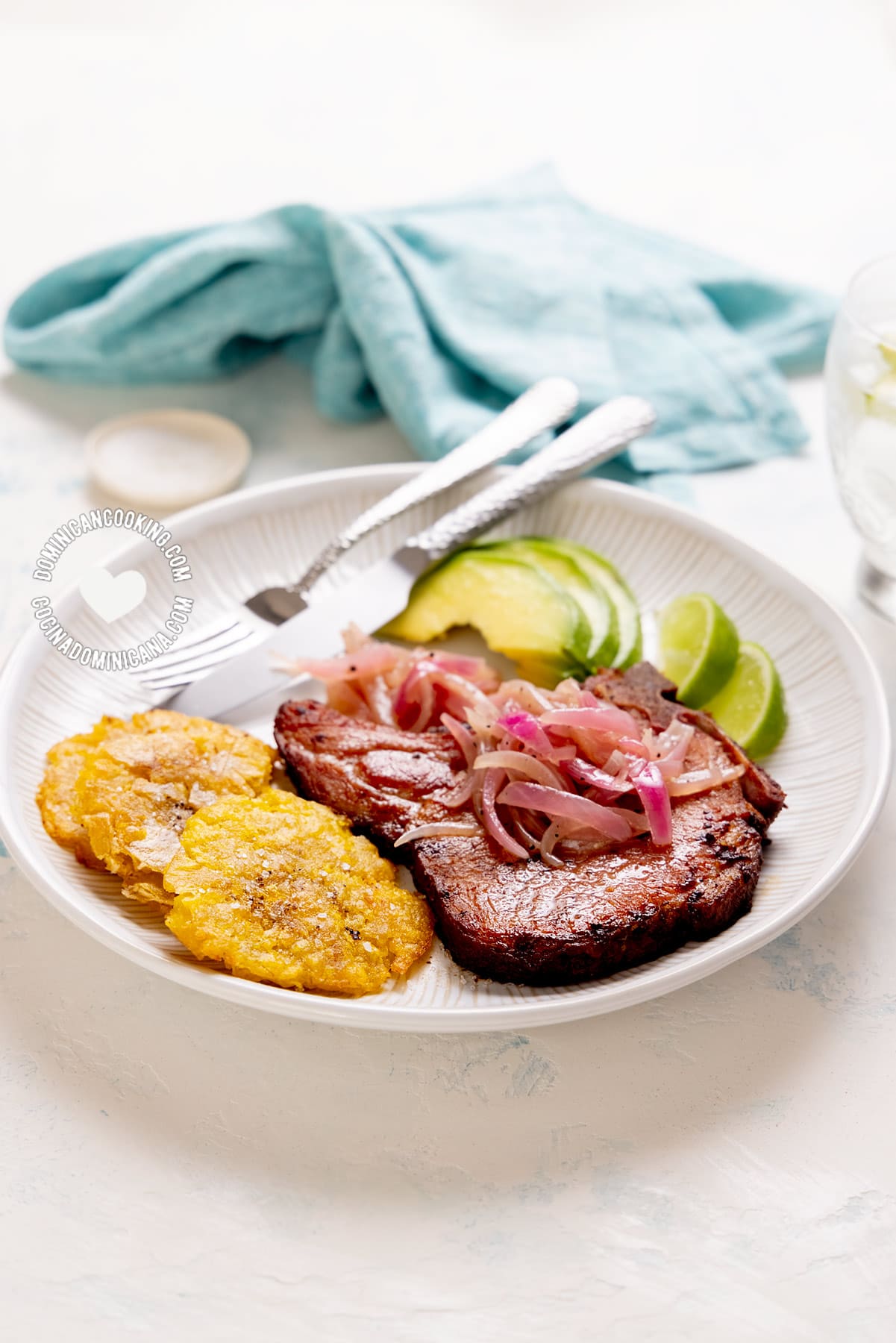 Chuletas fritas (Dominican fried smoked pork chops) with tostones and avocado.