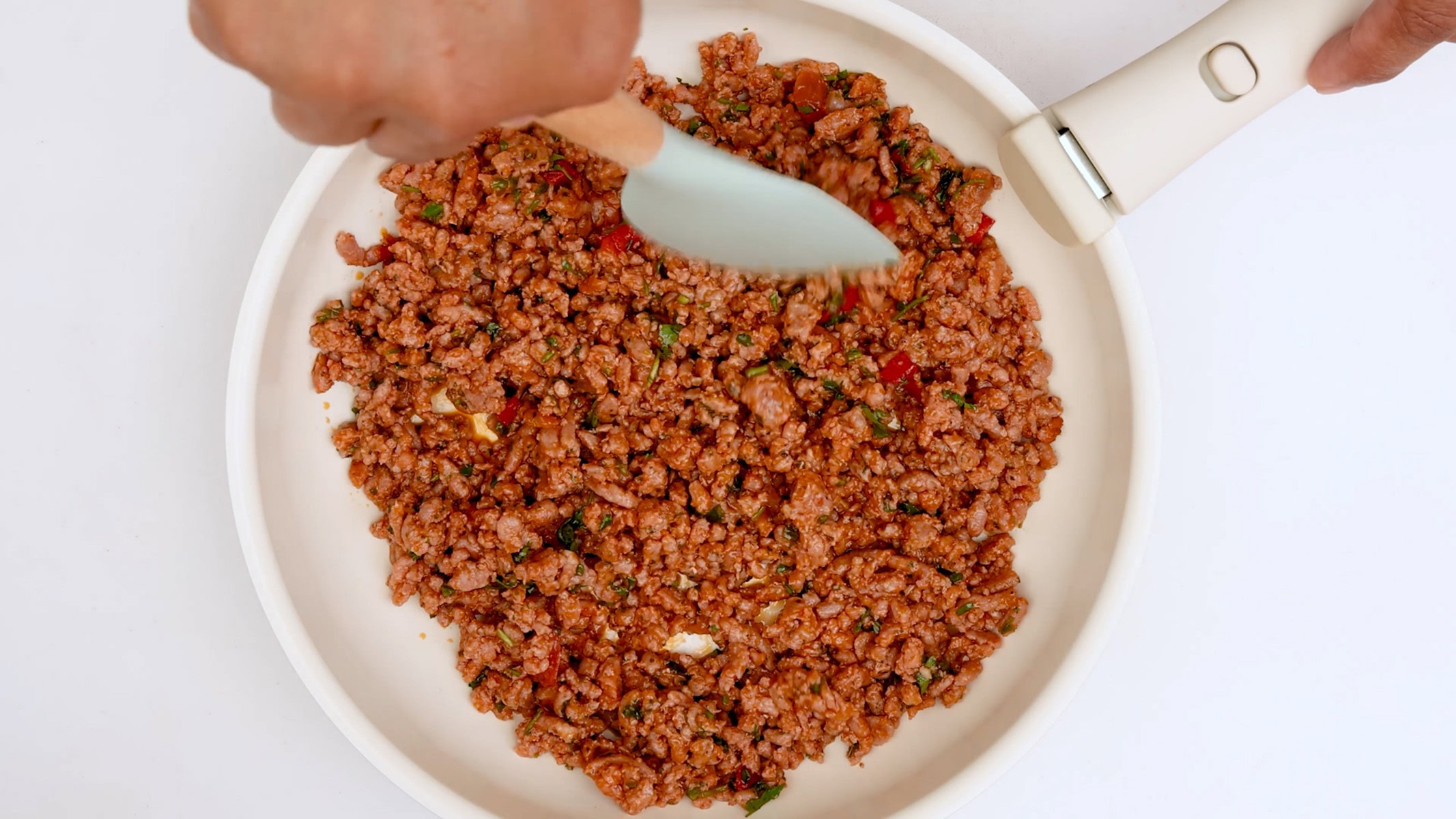 Cooking ground beef.