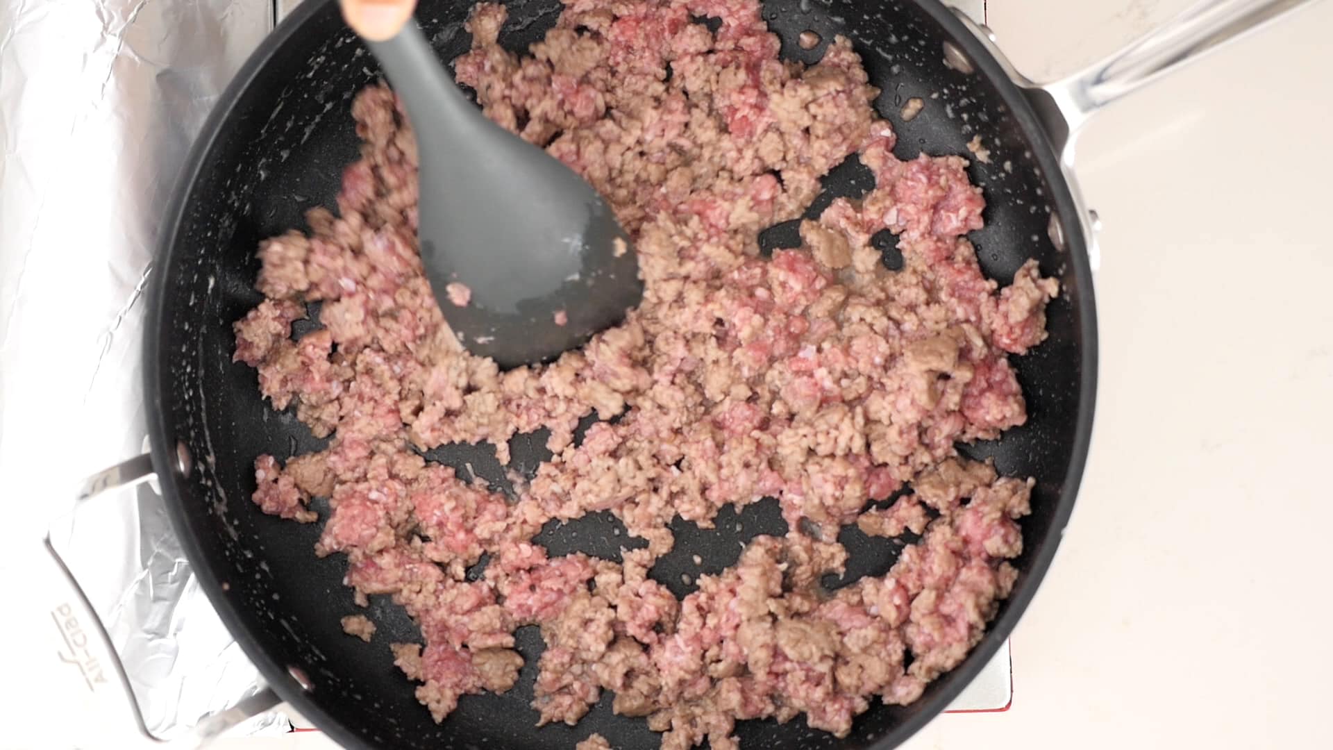 Cooking ground meat.