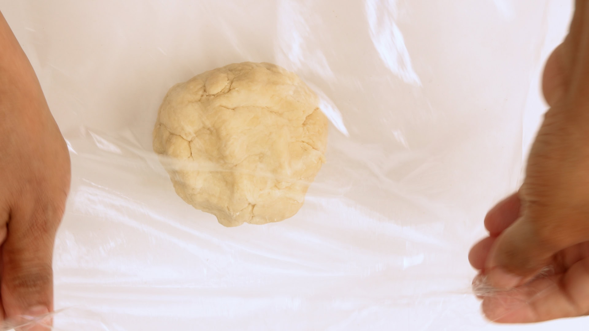 Covering dough with film.